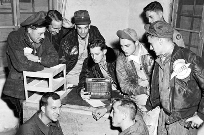 In Korea, F-86 Sabre pilots and other personnel of the 4th Fighter-Interceptor Wing listen to election returns over Armed Forces Radio Service in November 1952.