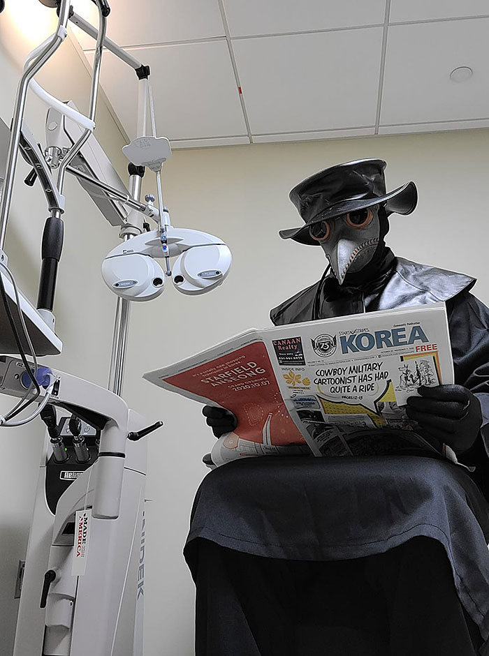 Plague doctor reads Stripes Korea