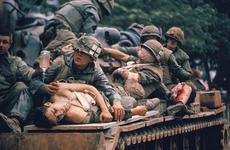 Pfc. A.B. Grantham, foreground, and other wounded Marines receive medical attention as they are evacuated on a tank during the fierce fighting of the Tet offensive. Grantham, an 18-year-old from Mobile, Ala., was unconscious and struggling to breathe after being shot in the chest.