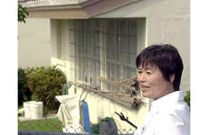 Setsuko Inafuku explains the history behind a house on Kadena that is considered haunted.
