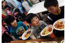 Children at Bikou-en Children's Care House wait in line for a home-cooked meal delivered March 27 by sailors from Naval Air Facility Misawa.