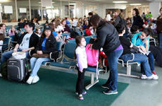 U.S. military family members wait to board a flight from Yokota Air Base, Japan, to Seattle, on Saturday.
