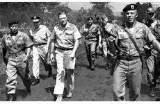 Pfc. Frank Orians of Grand Rapids, Mich., escorts Secretary of Defense McNamara and his entourage on a walk into an unsecured jungle area in Vietnam.