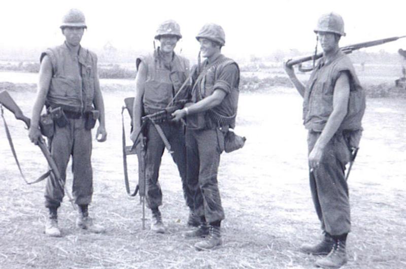 Marine Cpl. Gregory Harris, second from right, is seen here smiling with friends in Vietnam.