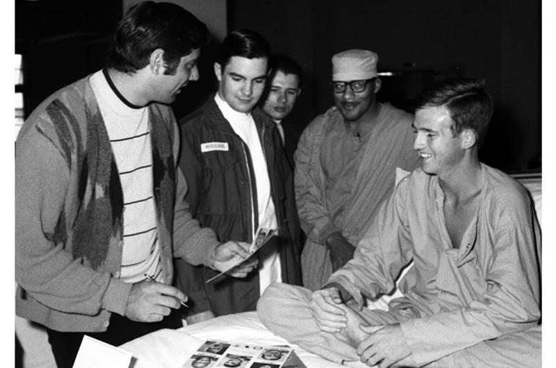 Joe Namath signs an autograph for Pfc. Henry Lock at the U.S. Army Hospital on Camp Oji, Japan, in January, 1969.