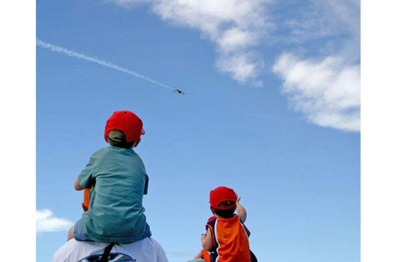 Hayden Froehlich, 5, left, was among the children using the shoulders of adult friends and parents to get a bird's-eye view of the Thunderbirds practice show on Saturday