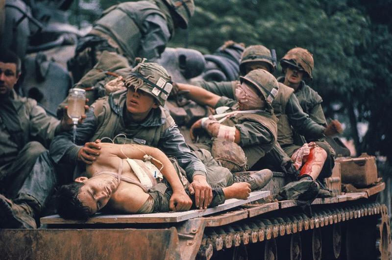Pfc. A.B. Grantham, foreground, and other wounded Marines receive medical attention as they are evacuated on a tank during the fierce fighting of the Tet offensive. Grantham, an 18-year-old from Mobile, Ala., was unconscious and struggling to breathe after being shot in the chest.