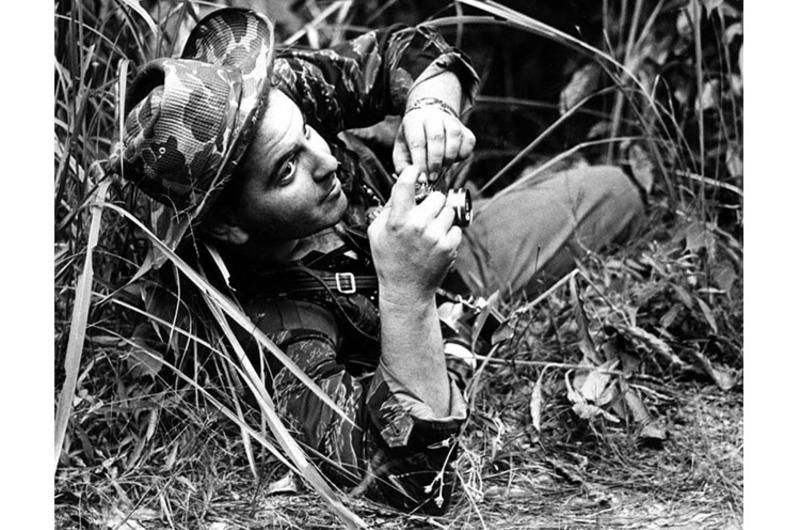 Former Stars and Stripes combat correspondent Steve Stibbens at work during an ambush in Vietnam in 1963.
