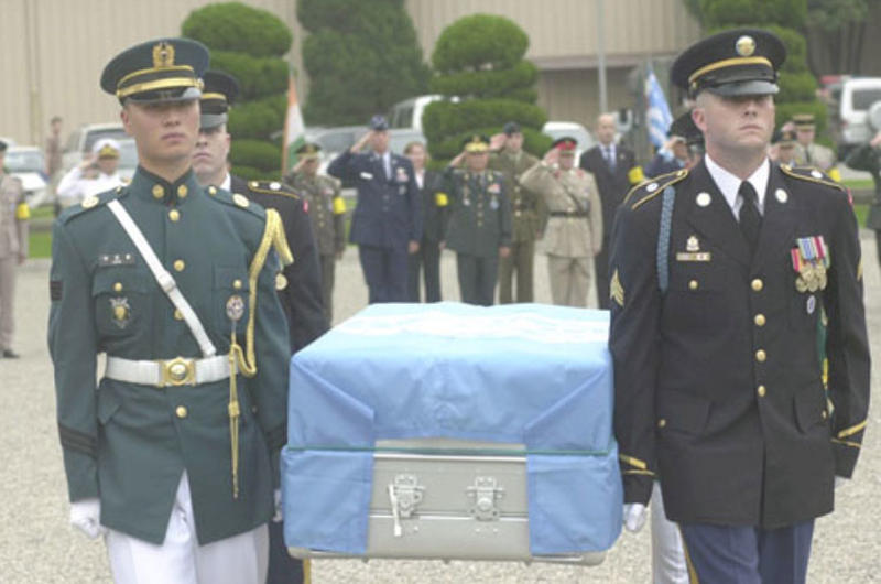 The remains of a U.S. soldier are carried to a waiting hearse Thursday on Knight Field at Yongsan Garrison.