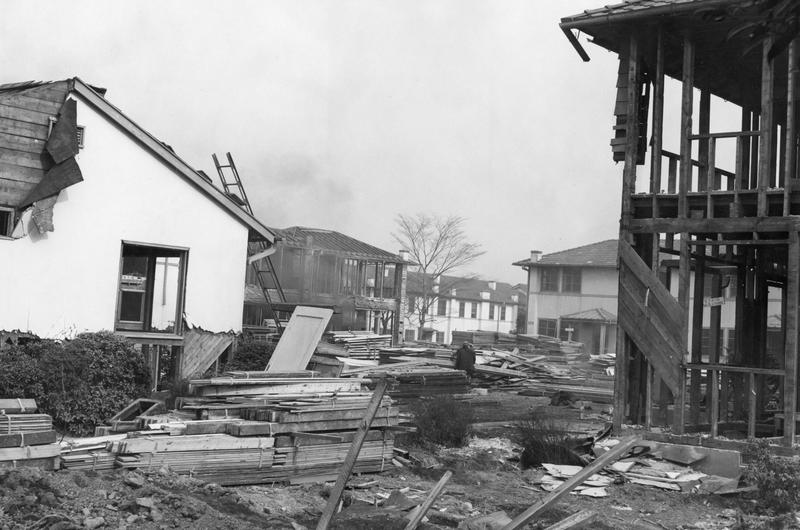 Crews tear down housing units to rebuild for the '64 Olympics.