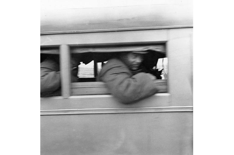U.N. prisoners of war peer through windows of communist ambulances as they arrive at Panmunjom April  20, 1953 for repatriation and exchange with Red captives.