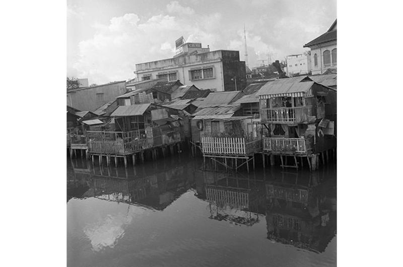 Houses built on top of pilings on a river in Saigon.
