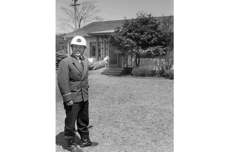 A Japanese official at the Olympic Village, the former U.S. Washington Heights housing area, points to the lone house that will be left standing in the village. The "little American village," returned to the Japanese to be used for the 1964 Olympics, is being torn down to make way for the new Yoyogi Forest Green Park.