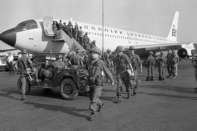 Fresh troops disembark from their airplane at an unidentified airport in Vietnam.