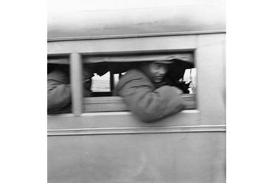 U.N. prisoners of war peer through windows of communist ambulances as they arrive at Panmunjom April  20, 1953 for repatriation and exchange with Red captives.