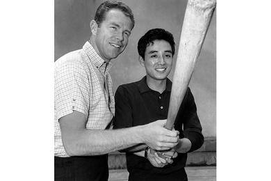 Mitsunaka Saito, Pacific Stars and Stripes copy boy, gets a batting tip from Gordy Windhorn, outfielder for the Hankyu Braves of Japan's Pacific League.