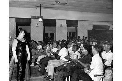 Singer-comedienne Alliene Flanery acknowledges the applause of enthusiastic spectators as she completes one of her numbers at the service club at Tan Son Nhut Airfield.